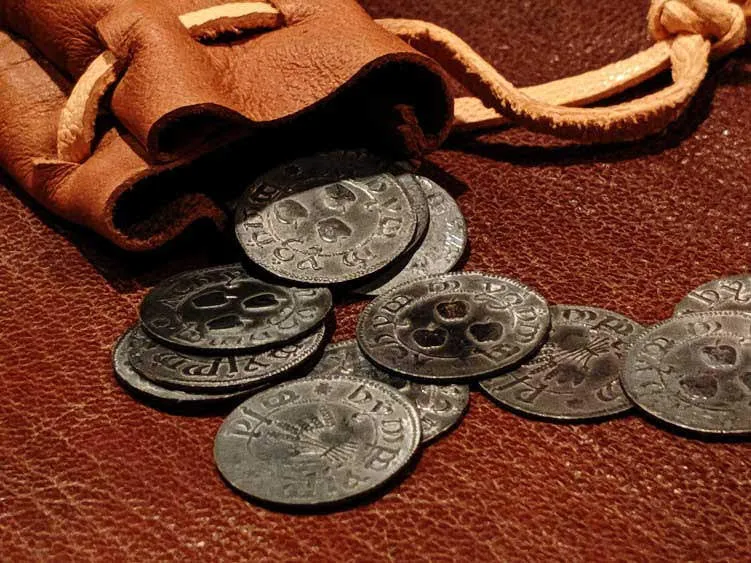 Silver pennies spilled from a leather purse