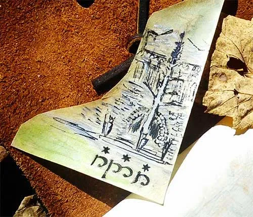 A painted leather piece showing the White Tree above a line of tengwar